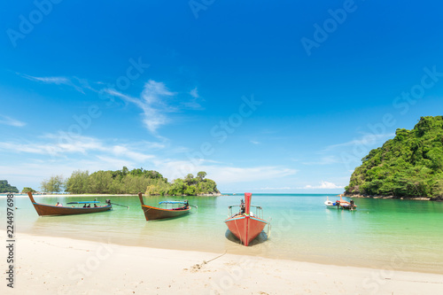 White sand beach and Long-tail boat at Kham-Tok Island (koh-kam-tok), The beautiful sea Ranong Province, Thailand.