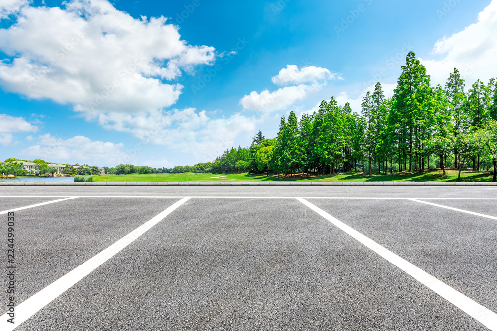 Asphalt road and woods with apartment buildings in the city suburbs Asphalt road and woods with apartment buildings in the city suburbs