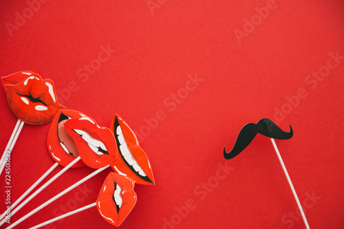 flatlay overhead top black paper photo booth props emotions lip and mustache red background copy space