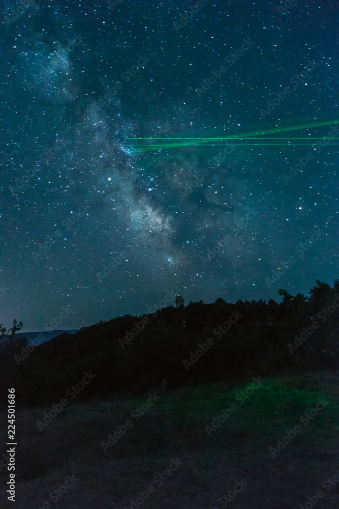 Milky Way over the mountains and laser pointers from astronomers