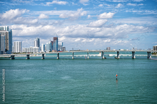 Miami, USA - 29 FEB 2016: Bridge over the Atlantic ocean in the middle of the sea. miami skyscrapers in coastline of usa with Venetian Causeway crosses Biscayne Bay. travel to usa, miami. photo