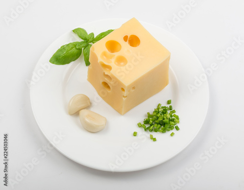 Restaurant Plate of Maasdam Cheese with Greens and Garlic photo