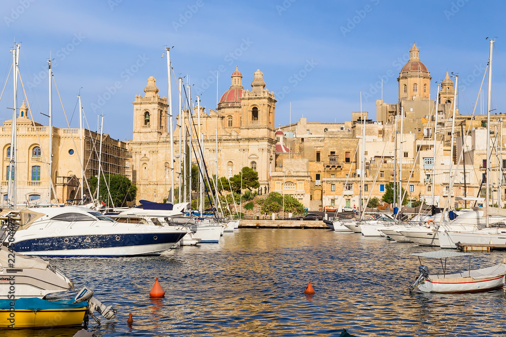 Birgu (Vittoriosa), Malta. Boat port of Vittoriosa in the background of the Church of St. Lawrence
