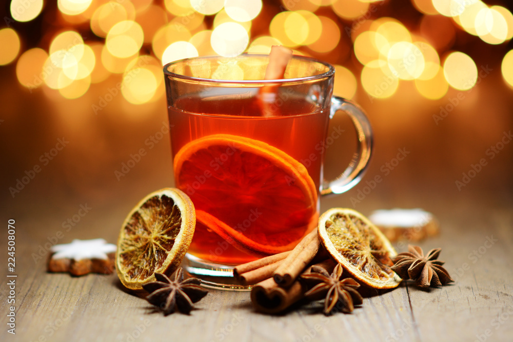 Punch, warm tea or mulled wine for Christmas with fairy lights as decoration and lighting Punch, warm tea or mulled wine for Christmas with fairy lights as decoration and lighting