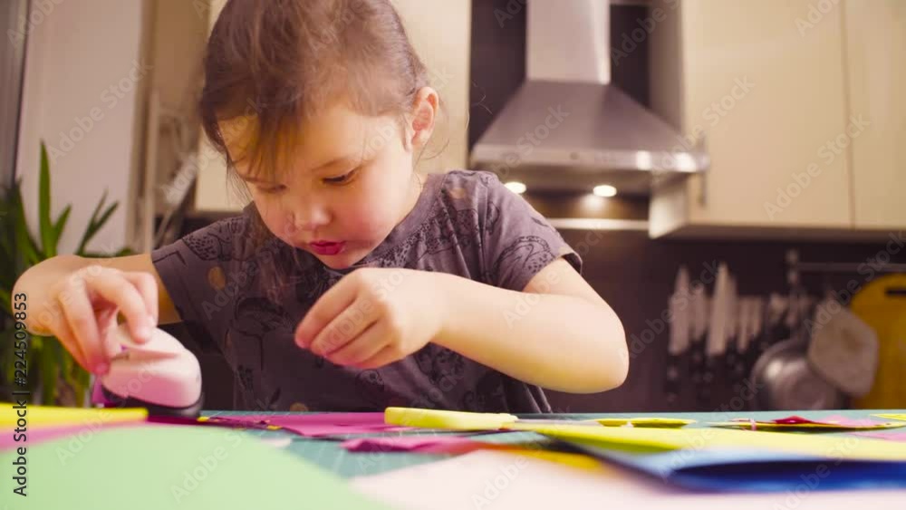 Scrapbooking. Little girl doing a postcard. Children's creativity, handicraft Scrapbooking. Little girl doing a postcard. Children's creativity, handicraft