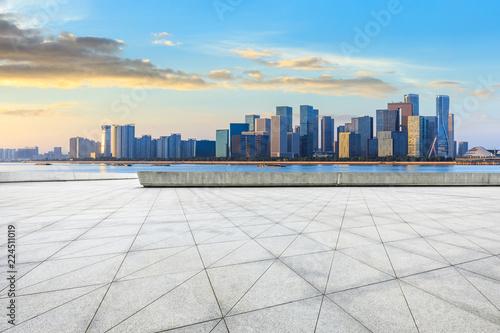 City square floor and modern buildings in hangzhou at sunrise