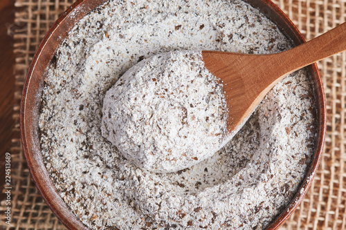 Organic buckwheat flour in wooden bowl on table. Top view