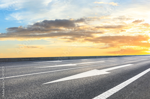 Clean asphalt highway and beautiful sky clouds at sunset