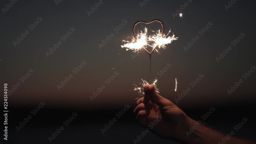 Bengal fire burns in the form of a heart. close-up Bengal fire burns in the form of a heart. close-up