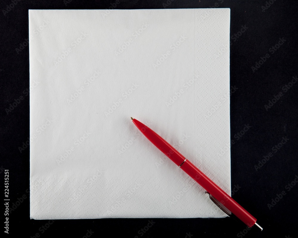 Ballpoint pen on folded white paper napkin Ballpoint pen on folded white paper napkin