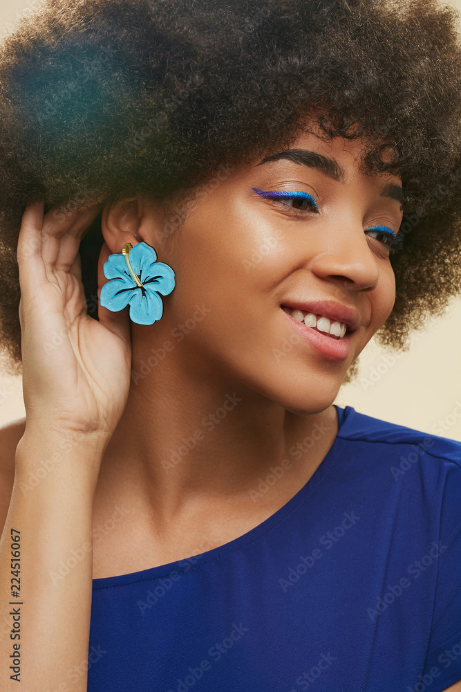 A close up portrait of a young African lady with short curly hair. The girl in A close up portrait of a young African lady with short curly hair. The girl in