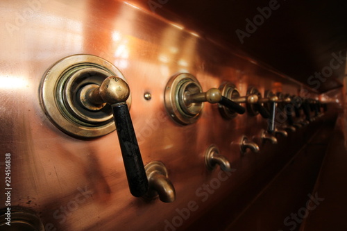 Amsterdam, Netherlands. Beer Tap in the Heineken Experience where is a historic brewery and corporate visitor center for the internationally distributed Dutch pilsner, Heineken beer.