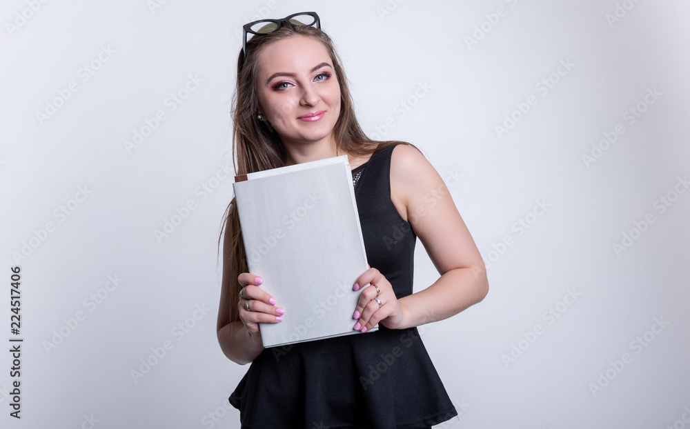 girl in glasses in a black dress with folders on a white background, office worker