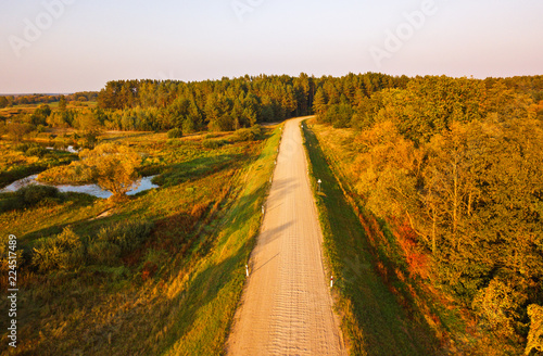 Rural dirt road view from above. Aerial view on countryside road with forest