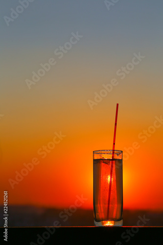 Glass beaker with water at sunset © Анна Медведева