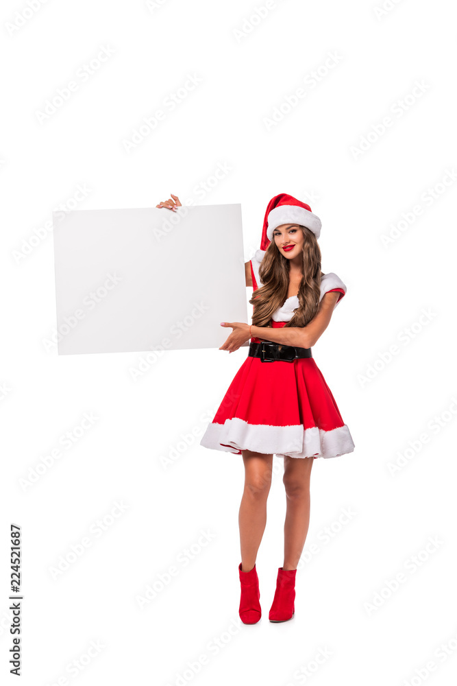 brunette girl in santa costume showing empty board, isolated on white brunette girl in santa costume showing empty board, isolated on white