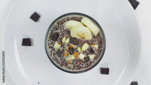 Chocolate chia pudding in glass on a white table. Healthy vegan breakfast.