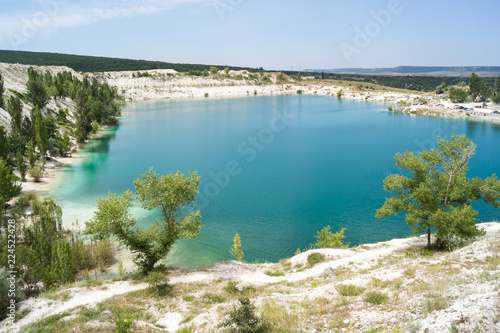 Bright blue water in the lake at the site of a limestone quarry