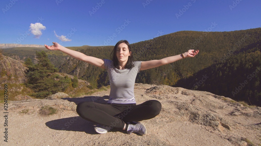 girl in the mountains sitting and doing yoga girl in the mountains sitting and doing yoga