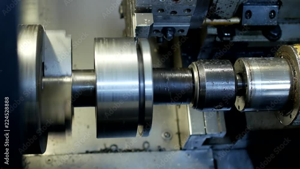 CNC lathe pulls out part of metal workpiece pulley, modern lathe for metal processing, close-up, metalworking CNC lathe pulls out part of metal workpiece pulley, modern lathe for metal processing, close-up, metalworking