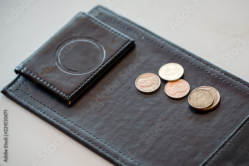 Close up money tip, notebank and coin on payment black leather tray. Service business and accounting concept photo