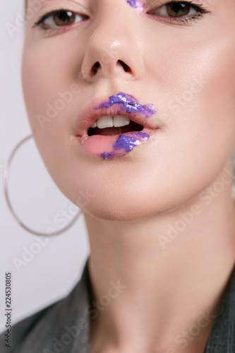 Beautiful emotional girl with creative and bright make-up on a white background