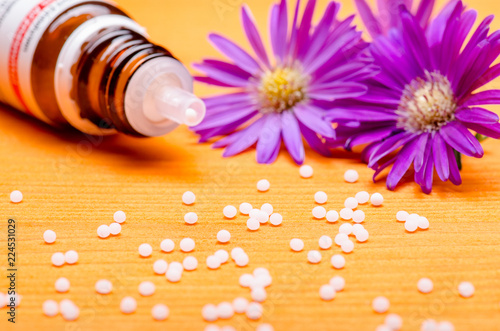 Obraz na plátně homeopathic globules on a orange wooden background