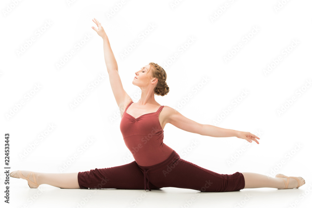 elegant adult woman doing gymnastics exercise while sitting on twine isolated on white background elegant adult woman doing gymnastics exercise while sitting on twine isolated on white background