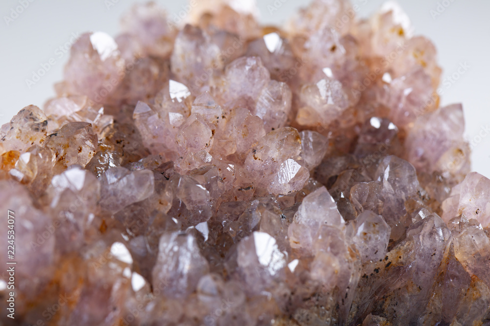 Natural Druse of amethyst on a white background stone Natural Druse of amethyst on a white background stone