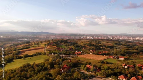 Aerial view of beautiful autumn sunset with a lot of clouds. Amazing colors and shadows of the clouds on the land. Landscape of village in Sumadija near the Kragujevac.