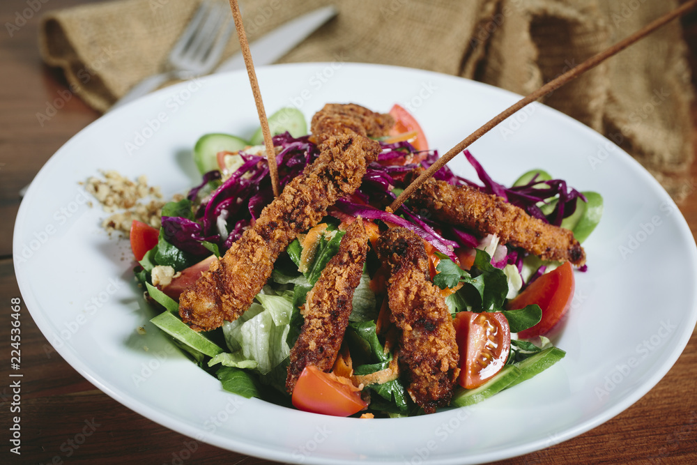 Delicious salad with chicken, nuts, egg and vegetables. Delicious salad with chicken, nuts, egg and vegetables.