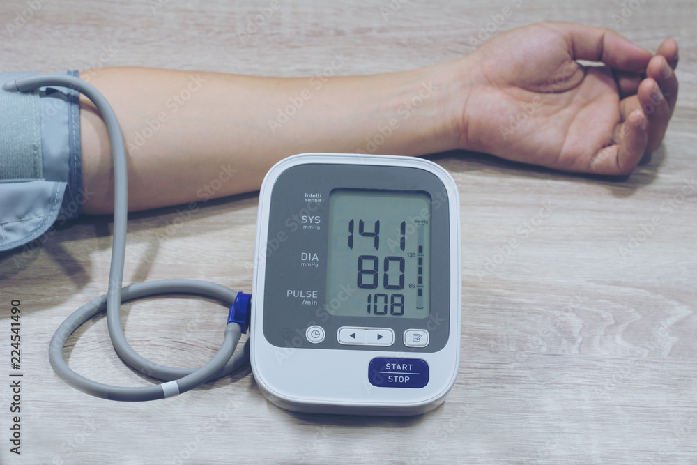 Man is taking care for health with hearth beat monitor and blood pressure. . Health concept Man is taking care for health with hearth beat monitor and blood pressure. . Health concept