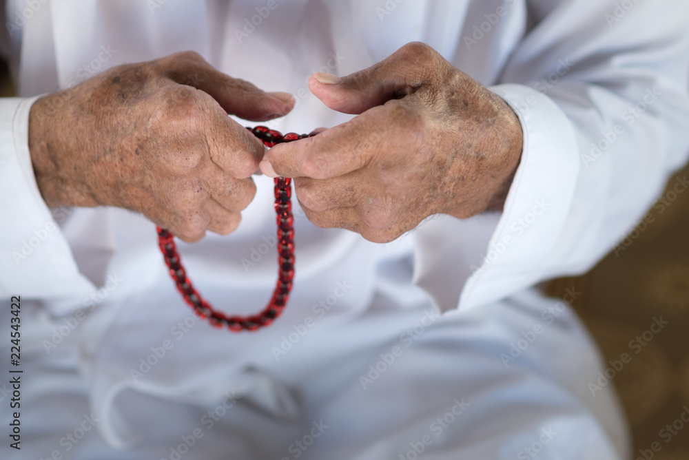 Arabic Bedouin Muslim man in traditional white holiday clothing.Praying ...