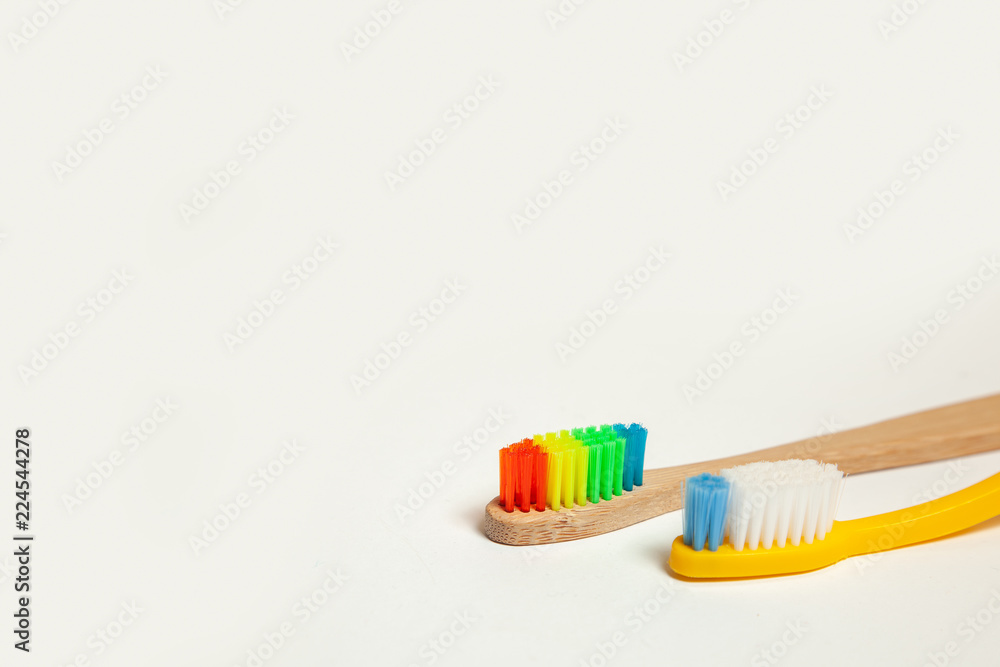 Toothbrushes on gray background. Concept toothbrush selection, bamboo eco-friendly and plastic