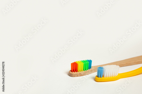 Toothbrushes on gray background. Concept toothbrush selection  bamboo eco-friendly and plastic