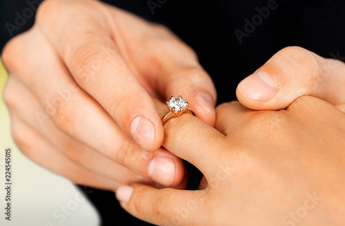 Close up Groom Putting the Wedding Ring