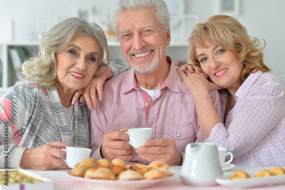 Portrait of senior people drinking tea at home