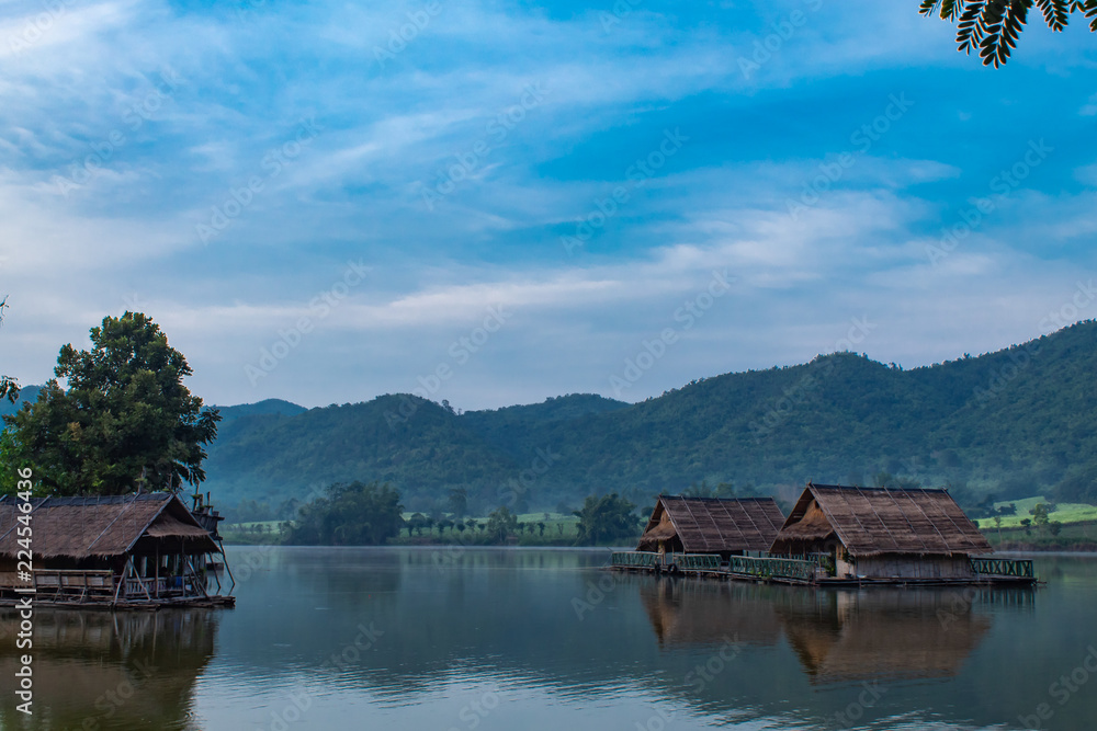 Naklejka premium The wooden raft in the water reservoirs and mountain views.
