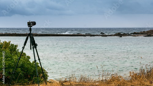 Camera taking picture film of sea coast