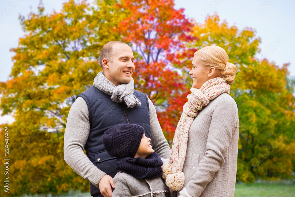 family, season and people concept - happy mother, father and son over autumn park background