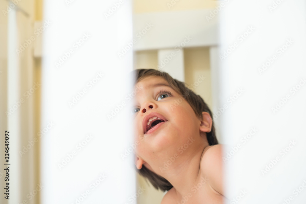 Cute baby boy toddler - in the crib - observing Cute baby boy toddler - in the crib - observing