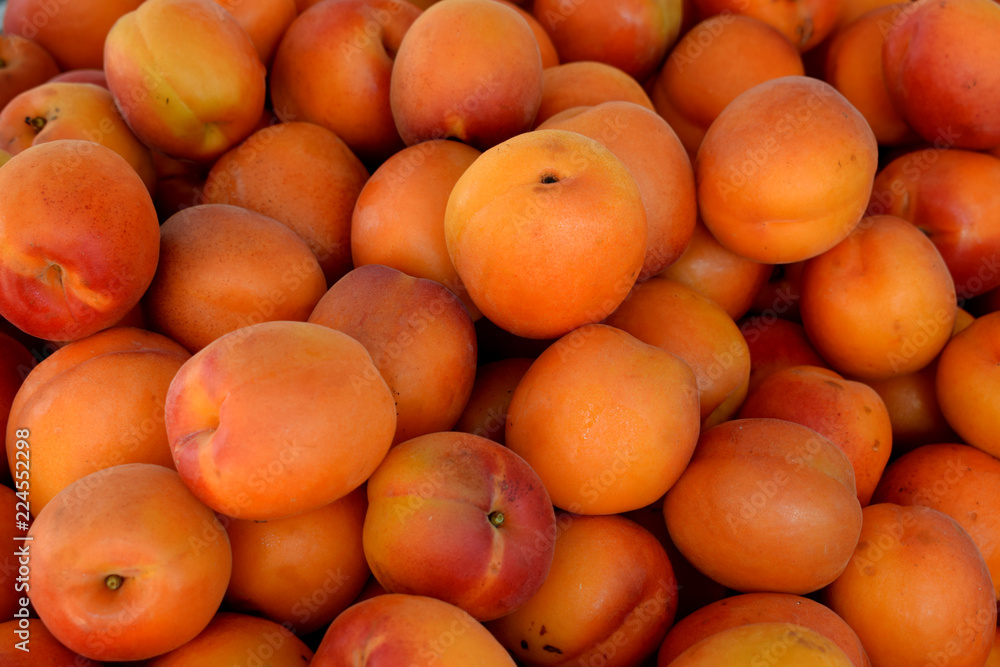 Fresh ripe apricots and peaches on the market counter Fresh ripe apricots and peaches on the market counter