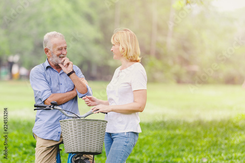 Senior couple walking their bike photo