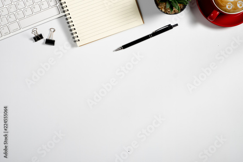 Workspace with computer, colour pencils and coffee mug on white background. Flat lay, top view