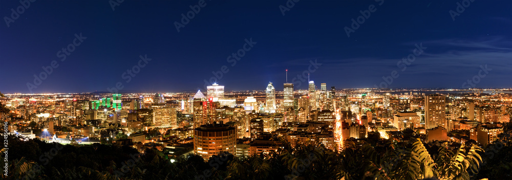 Montreal at night, view from Belvedere with amazing autumn colorful leaves. Beautiful panorama of Montreal downtown skyline in the fall night time.