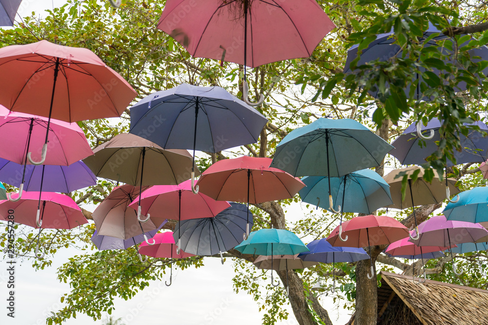 The sky of colorful umbrellas background.Street decoration.Colorful Hanging Umbrellas