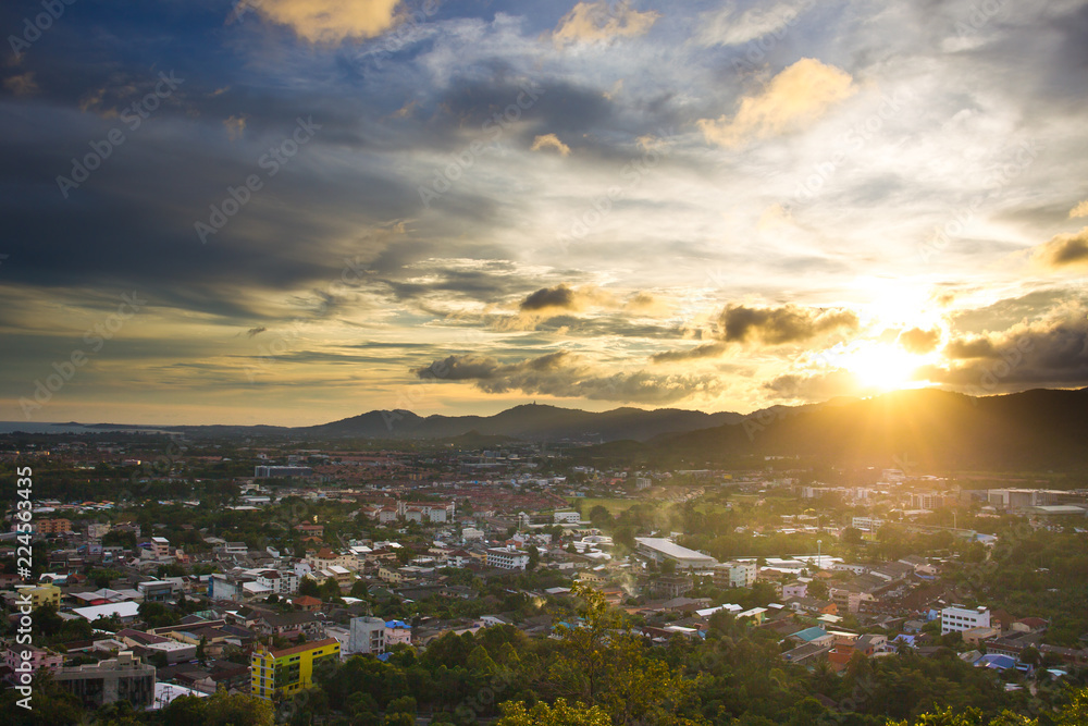 Fototapeta premium Landscape of down town and mountain during the sunset.