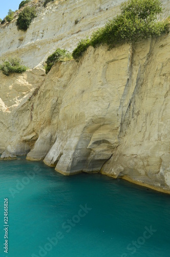 Nice Greenish Blue Tone Of The Sea United To The Molten Limestone Rock In Some Beautiful Rays Of Sun By Canal De Corinto. Architecture, Travel, Landscapes. July 8, 2018.Corinth Canal Greece.