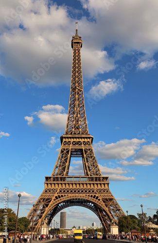Very high Eiffel Tower and the blue sky with clouds