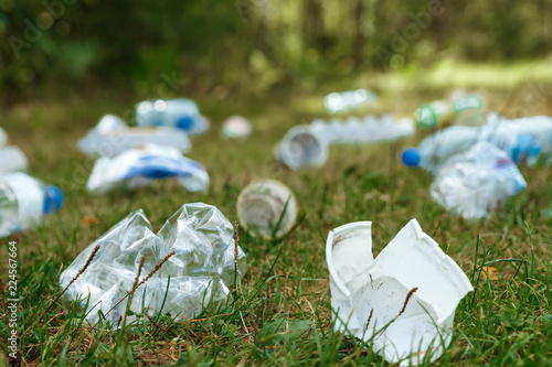 A pile of plastic on green grass, a problem in the natural environment, pollution of nature is not decomposing plastic. Protection of Nature. copy space